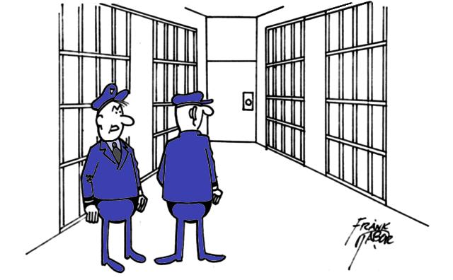 Two prison guards between cells talking. . .