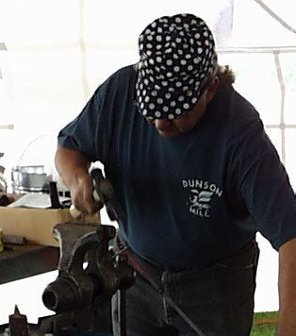 Frank Turley finishing a spoon on a vise handle.