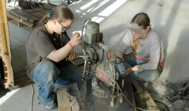Girls using magnetic base drill press