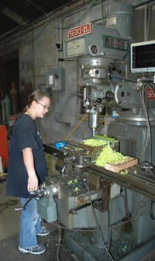 Student on milling machine.